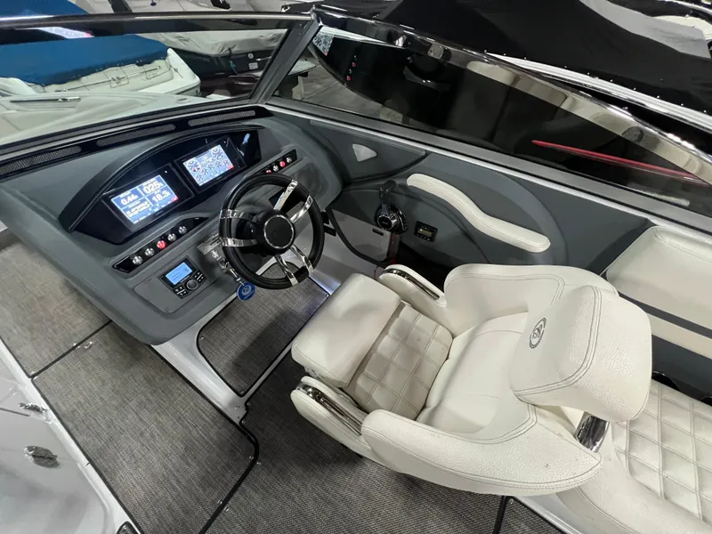 Slide: The Image of 2018 Cobalt R5 boat interior with modern dashboard and white leather seating. - 14