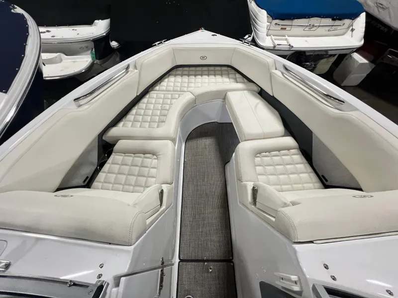 Slide: The Image of 2018 Cobalt R5 boat interior with white cushioned seating and sleek design. - 17