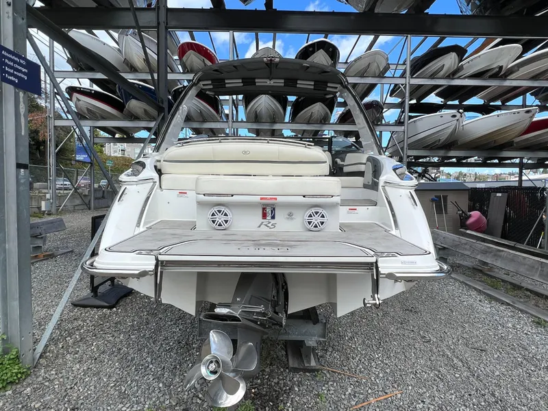 Slide: The Image of 2018 Cobalt R5 boat in storage, rear view with multiple boats stacked above. - 22