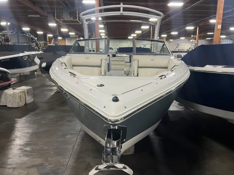 Slide: The Image of 2018 Cobalt R5 boat in showroom, front view, sleek design, white and gray color. - 3