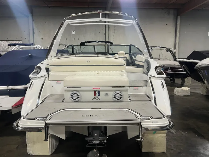 Slide: The Image of 2018 Cobalt R5 boat in showroom, rear view with seating and swim platform. - 5