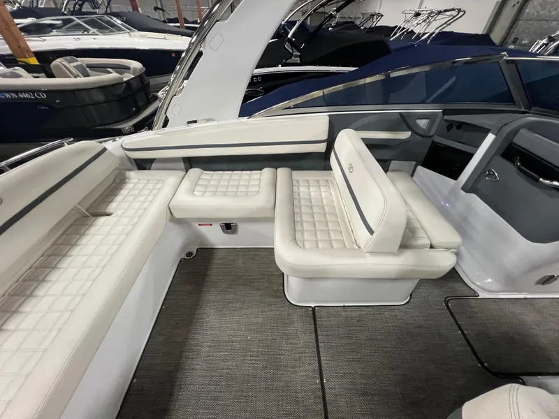 Slide: The Image of 2018 Cobalt R5 boat interior with white cushioned seating and sleek design. - 8