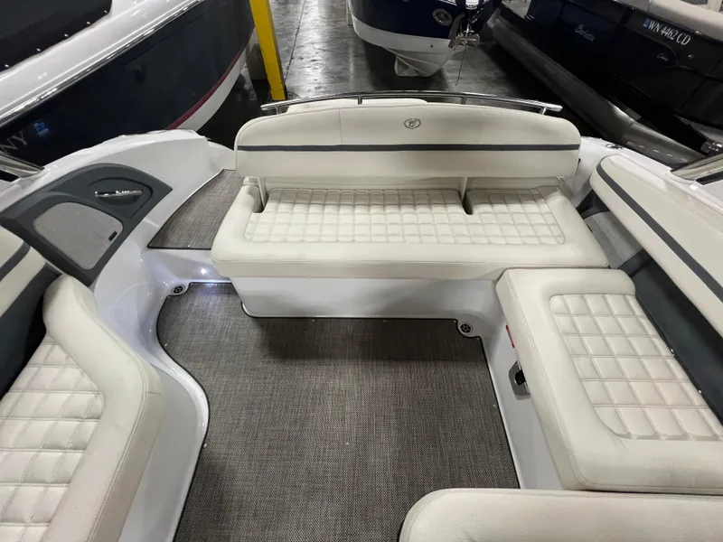 Slide: The Image of 2018 Cobalt R5 boat interior with white cushioned seating and gray flooring. - 9