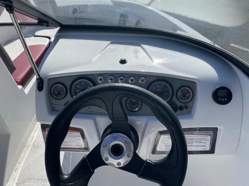 Slide: The Image of 2024 Tahoe 185 S boat dashboard with steering wheel and instrument panel. - 6