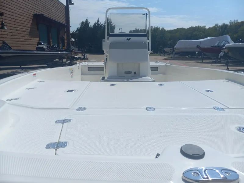 Slide: The Image of 2024 Mako Pro Skiff 19 CC boat deck and console in a marina. - 4
