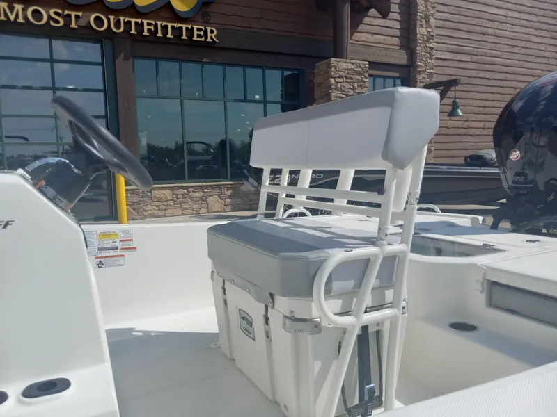 Slide: The Image of 2024 Mako Pro Skiff 19 CC boat interior with seating and steering wheel. - 6