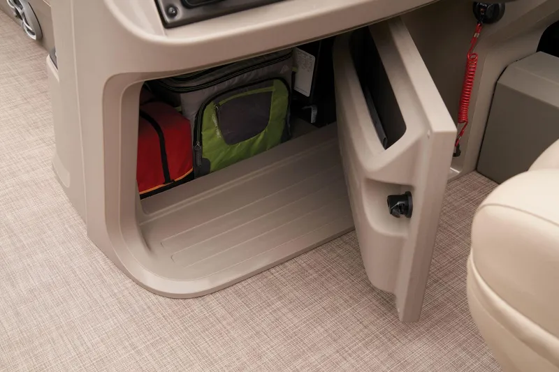 Slide: The Image of Storage compartment in 2024 Sun Tracker SportFish 22 DLX boat with bags inside. - 32