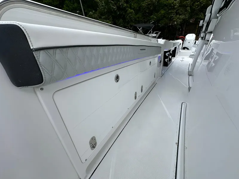 Slide: The Image of 2024 Blackfin 400 CC boat interior with white seating and built-in speakers. - 27