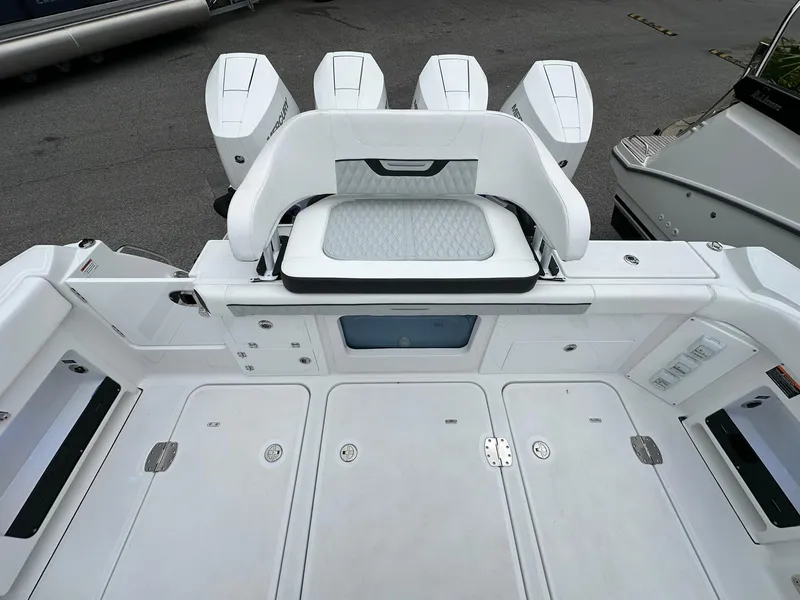 Slide: The Image of 2024 Blackfin 400 CC boat interior with speaker, cup holders, and quilted upholstery. - 30