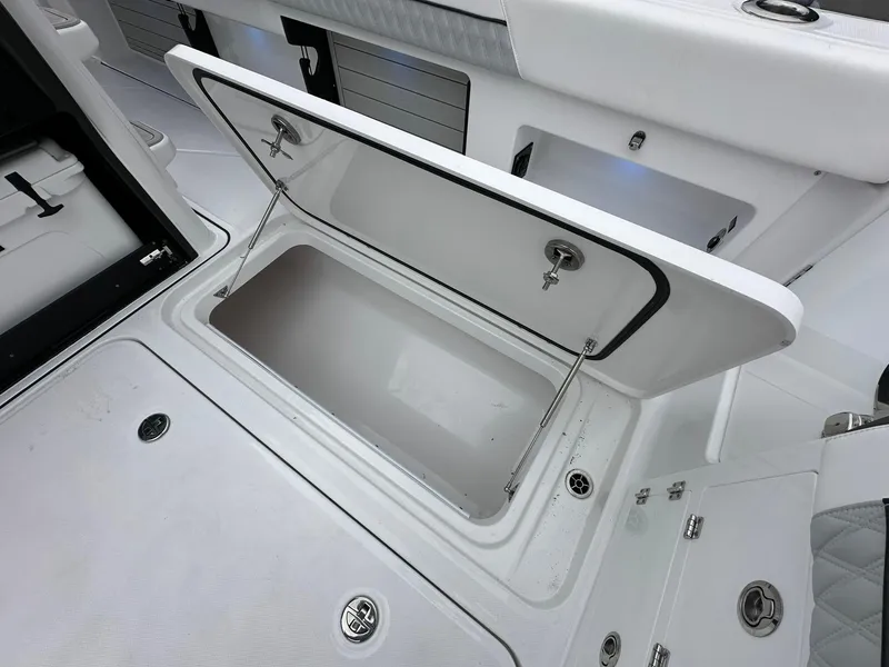 Slide: The Image of 2024 Blackfin 400 CC boat interior with rod holders and cushioned side panel. - 39