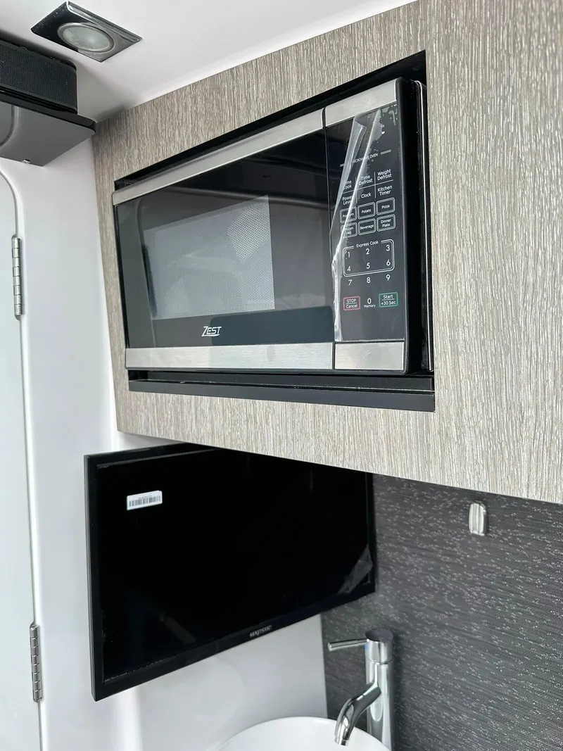 Slide: The Image of 2024 Blackfin 400 CC interior cabin with fishing rod storage. - 52