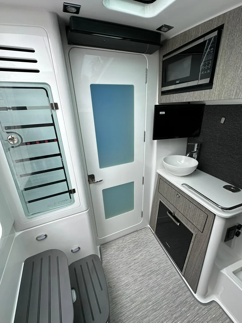 Slide: The Image of Interior of 2024 Blackfin 400 CC boat with seating and fishing rod holders. - 53