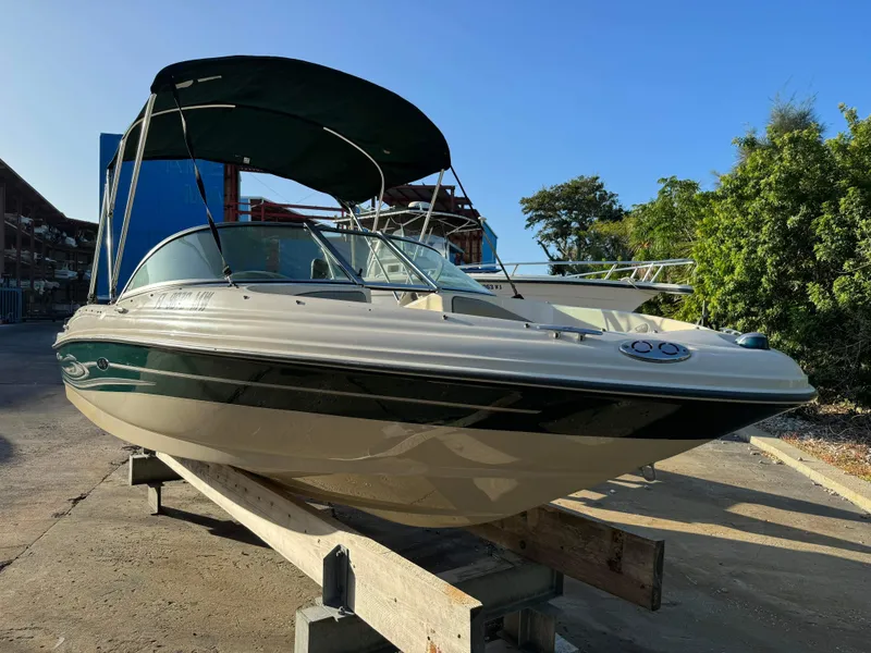 Slide: The Image of 2005 Sea Ray 180 Sport boat with canopy in storage yard. - 11