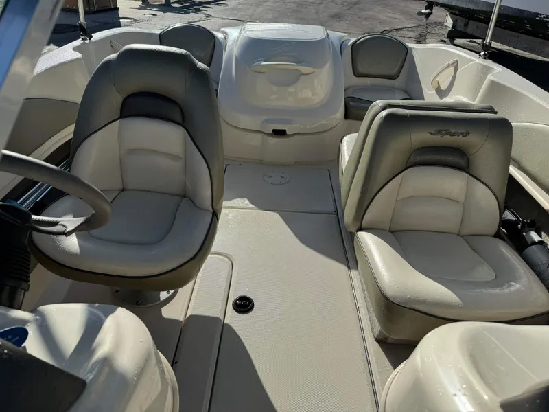Slide: The Image of Interior of a 2005 Sea Ray 180 Sport boat with beige and gray seating. - 13