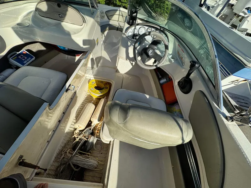 Slide: The Image of Interior of a 2005 Sea Ray 180 Sport boat showing storage compartments and steering console. - 15