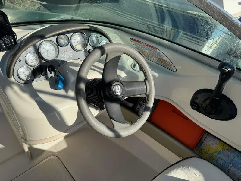 Slide: The Image of 2005 Sea Ray 180 Sport boat dashboard with steering wheel and instrument panel. - 16