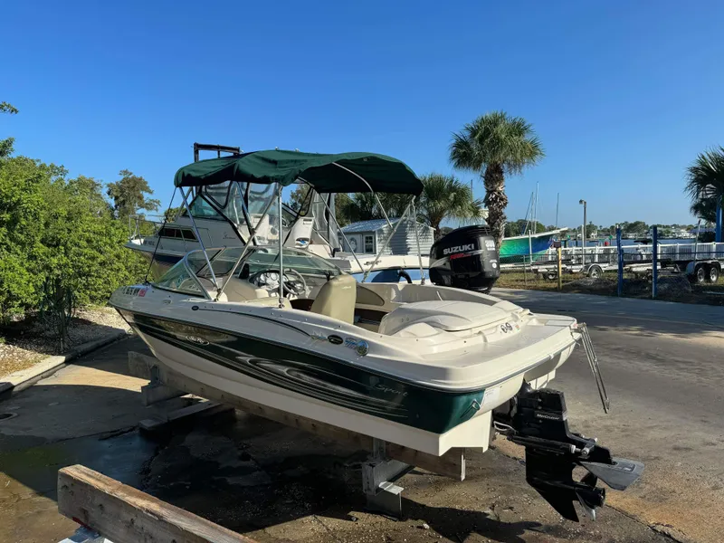 Slide: The Image of 2005 Sea Ray 180 Sport boat with Suzuki outboard motor on a sunny day. - 2