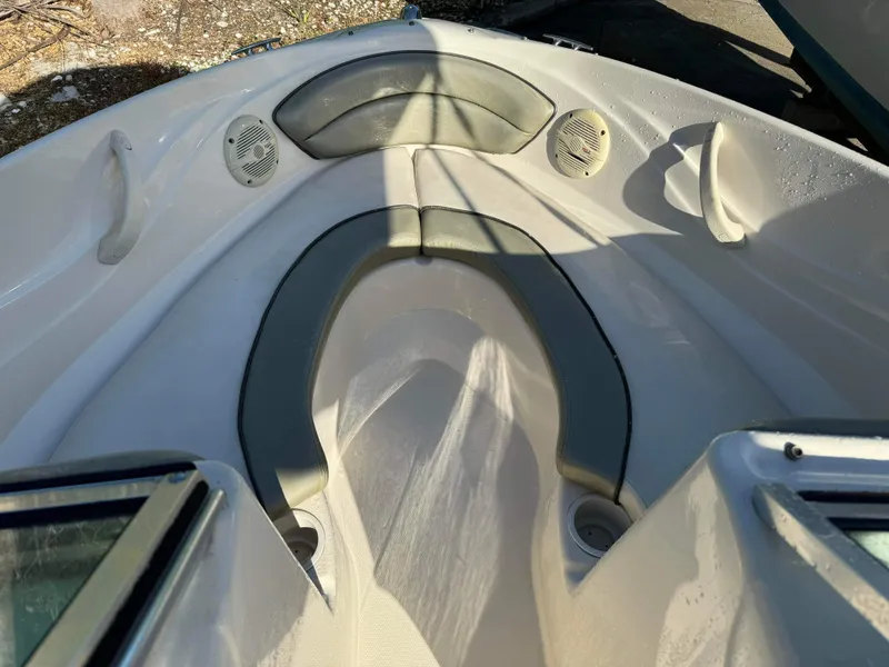 Slide: The Image of Interior bow seating of a 2005 Sea Ray 180 Sport boat with speakers and cup holders. - 21