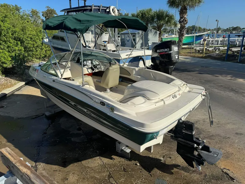 Slide: The Image of 2005 Sea Ray 180 Sport boat with green canopy and Suzuki outboard motor. - 24