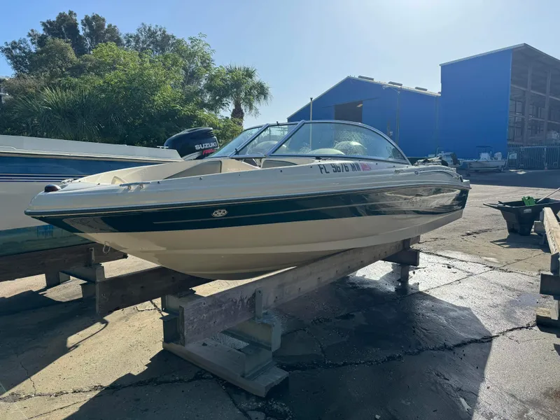 Slide: The Image of 2005 Sea Ray 180 Sport boat on a dock, with Suzuki outboard motor. - 28