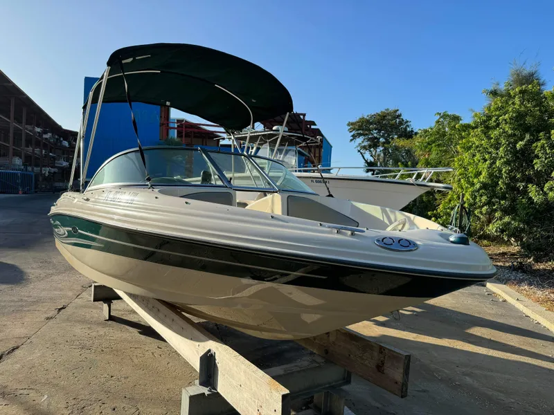 Slide: The Image of 2005 Sea Ray 180 Sport boat with canopy in a marina. - 3