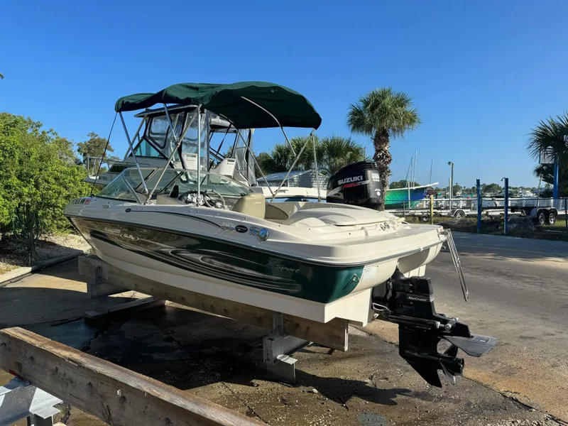 Slide: The Image of 2005 Sea Ray 180 Sport boat with Suzuki outboard motor on a dock. - 31
