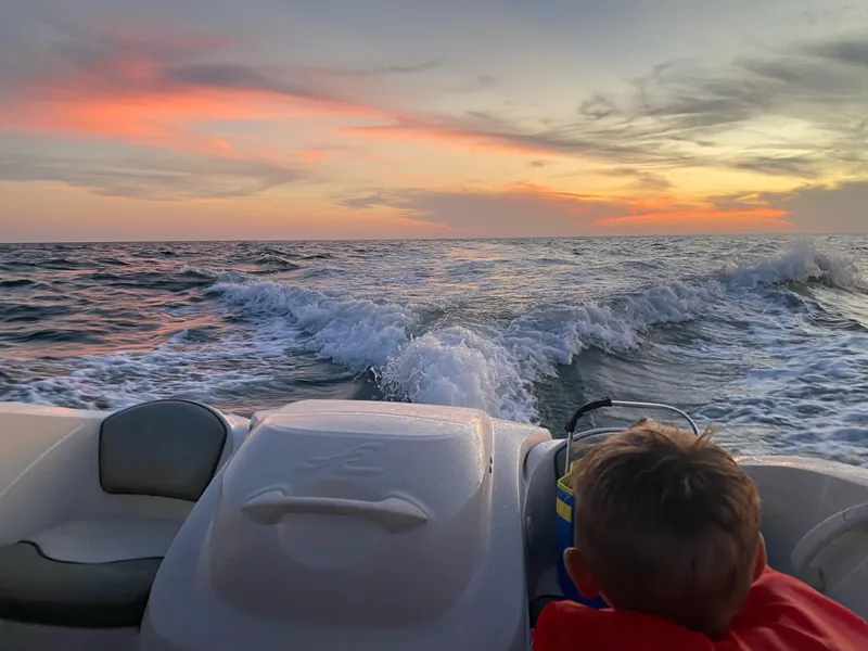 Slide: The Image of Child enjoying sunset on a 2005 Sea Ray 180 Sport boat. - 39