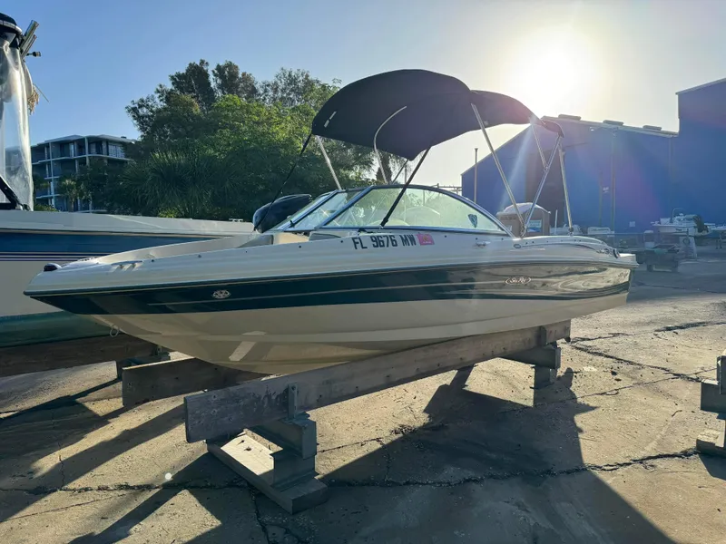 Slide: The Image of 2005 Sea Ray 180 Sport boat on a wooden stand in a marina. - 4