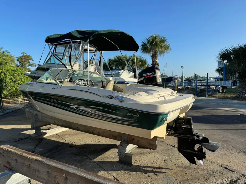 Slide: The Image of 2005 Sea Ray 180 Sport boat on a stand, with Suzuki outboard motor. - 5