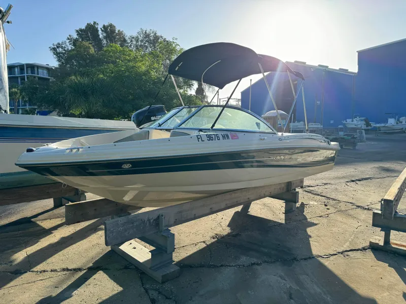 Slide: The Image of 2005 Sea Ray 180 Sport boat on dry dock with canopy in marina. - 8
