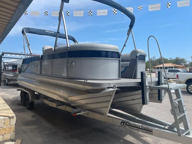 The Image of 2022 Manitou Oasis 23 SL SHP373 pontoon boat on a McClain trailer. - 1