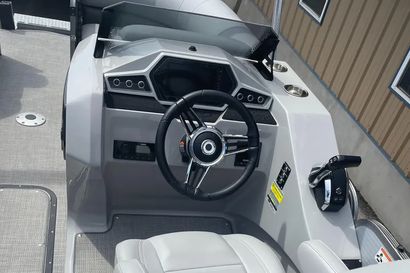 Slide: The Image of 2022 Manitou Oasis 23 SL SHP373 boat cockpit with steering wheel and controls. - 10