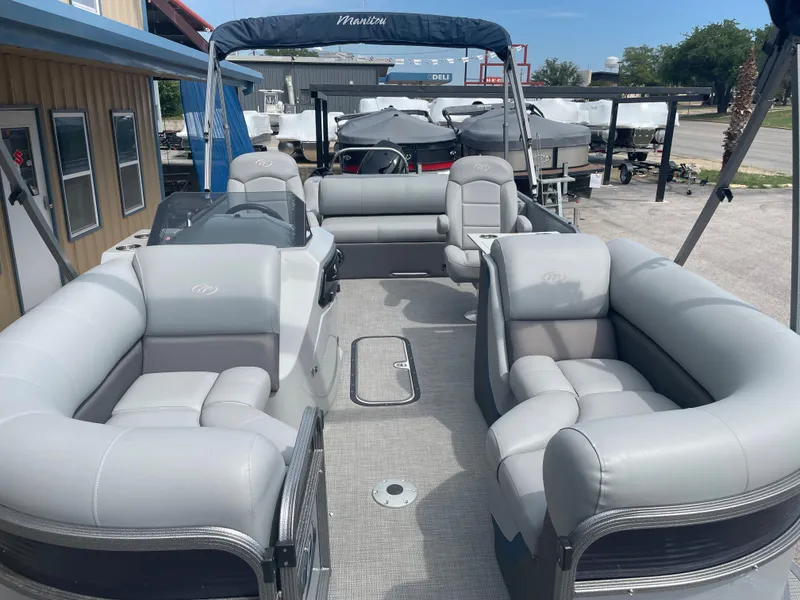 Slide: The Image of 2022 Manitou Oasis 23 SL SHP373 pontoon boat with spacious seating and canopy. - 3