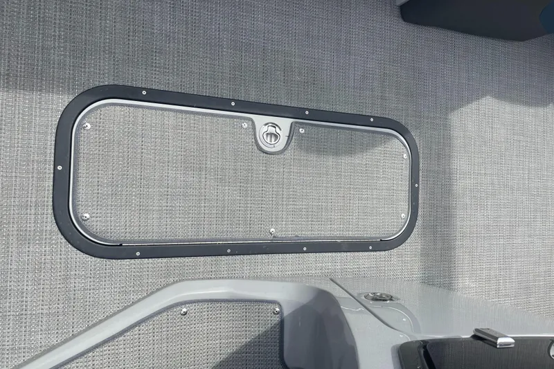 Slide: The Image of 2022 Manitou Oasis 23 SL SHP373 boat storage compartment. - 8
