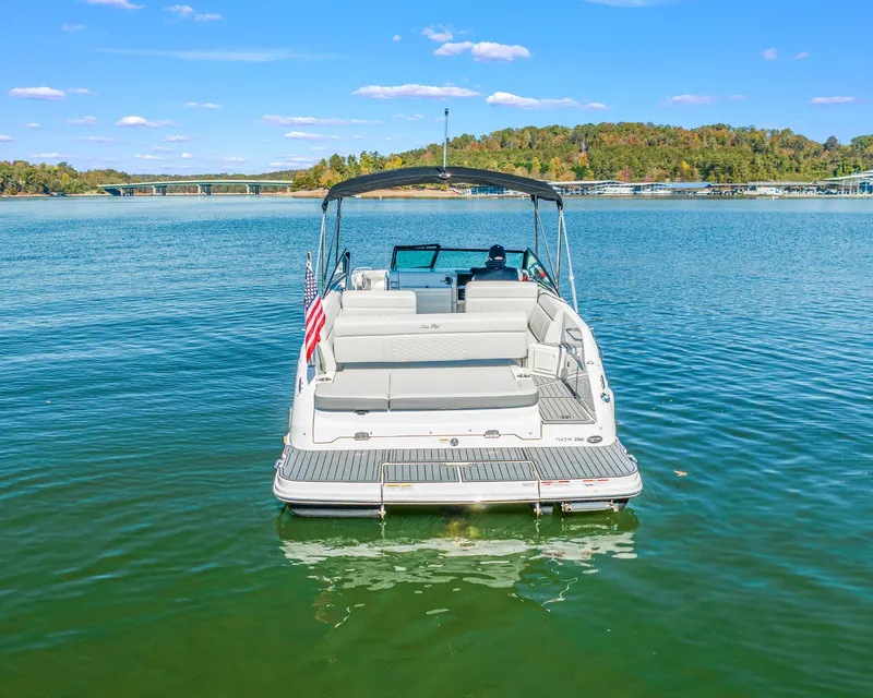 Slide: The Image of 2021 Sea Ray SDX 250 boat on a serene lake with clear skies. - 1
