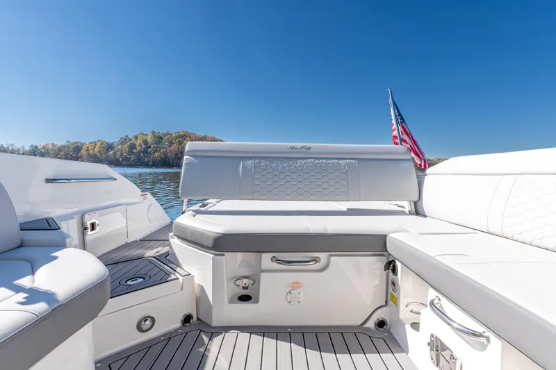 Slide: The Image of 2021 Sea Ray SDX 250 boat interior with seating, lake view, and American flag. - 11