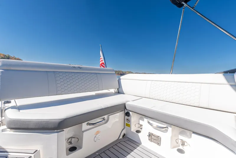Slide: The Image of 2021 Sea Ray SDX 250 boat interior with white seating and American flag. - 12