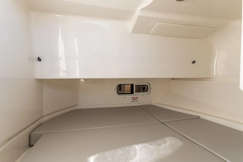 Slide: The Image of Interior cabin of 2021 Sea Ray SDX 250 boat, featuring sleek white design. - 28