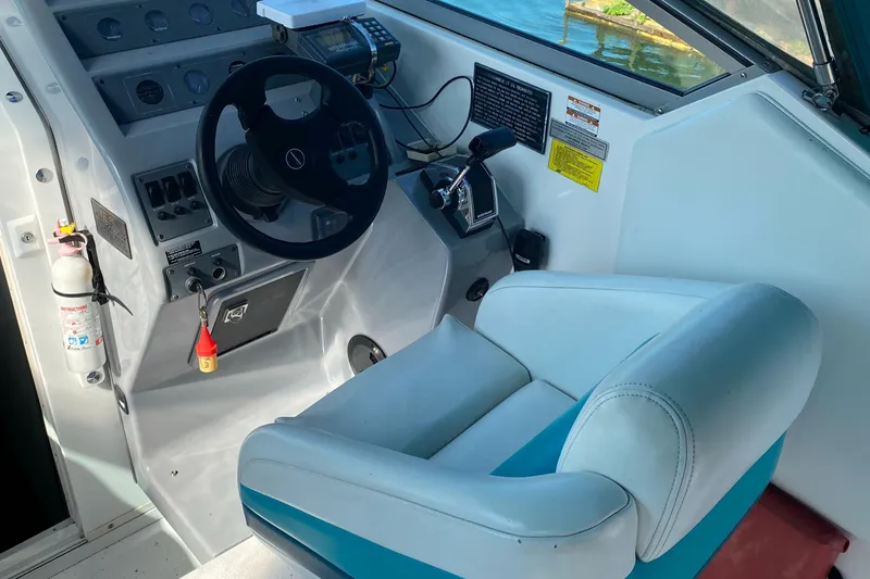 Slide: The Image of 1993 Chaparral 280 SIGNATURE boat cockpit with steering wheel and control panel. - 4