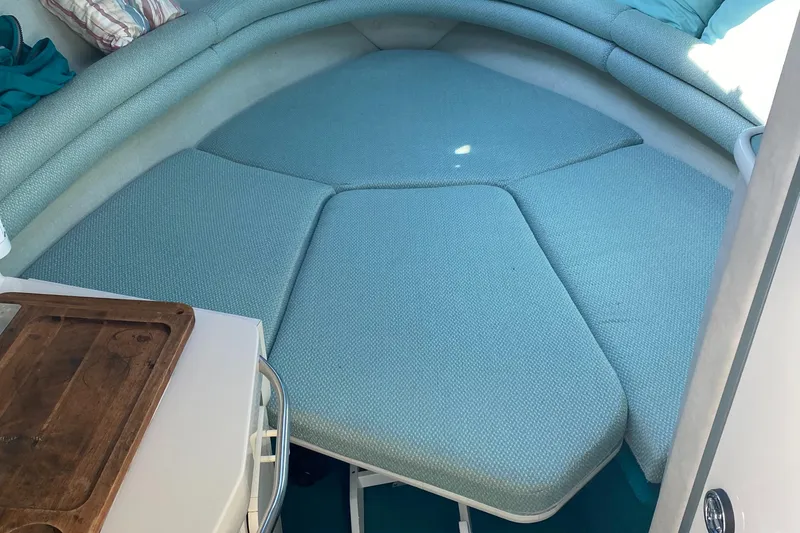 Slide: The Image of 1993 Chaparral 280 SIGNATURE cabin interior with teal upholstery and wooden table. - 5