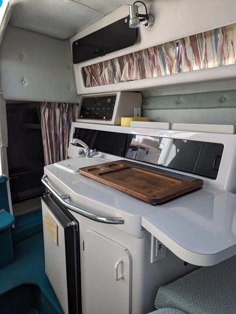 Slide: The Image of 1993 Chaparral 280 SIGNATURE boat interior with kitchenette and modern amenities. - 9