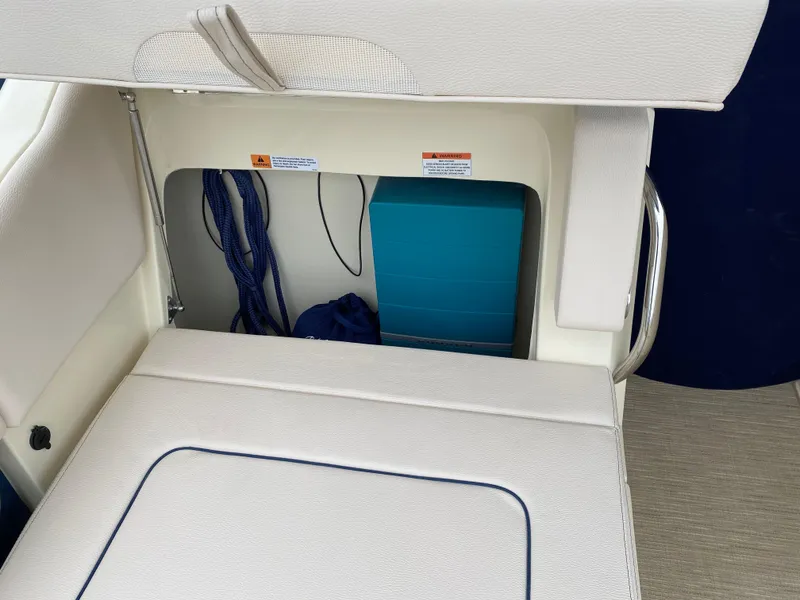 Slide: The Image of 2024 Chris-Craft Calypso 32 boat with open storage compartment under seat. - 10