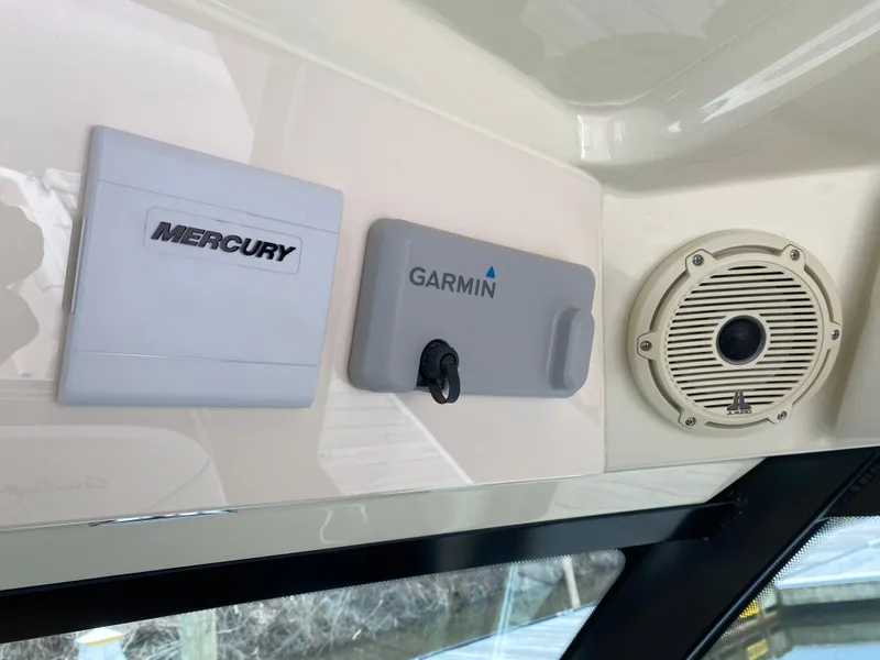 Slide: The Image of 2024 Chris-Craft Calypso 32 helm controls and joystick on black console. - 14