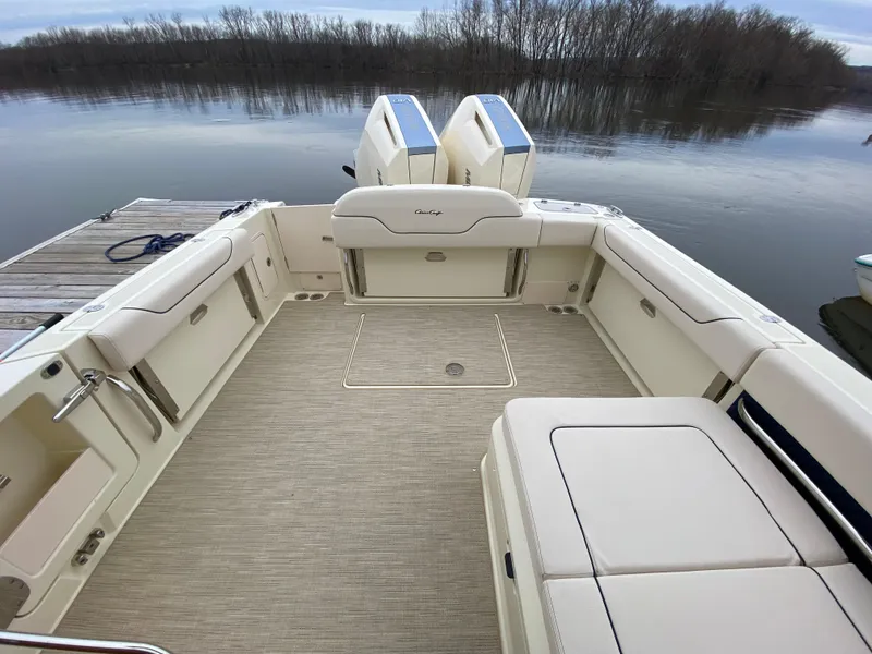 Slide: The Image of 2024 Chris-Craft Calypso 32 boat on a calm lake with a forested background. - 3