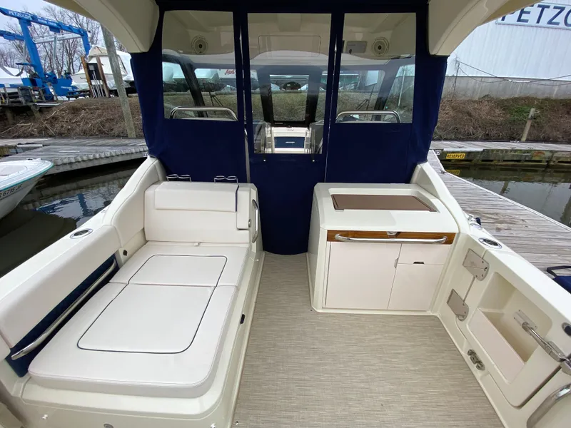 Slide: The Image of 2024 Chris-Craft Calypso 32 boat with spacious seating and twin outboard engines. - 5