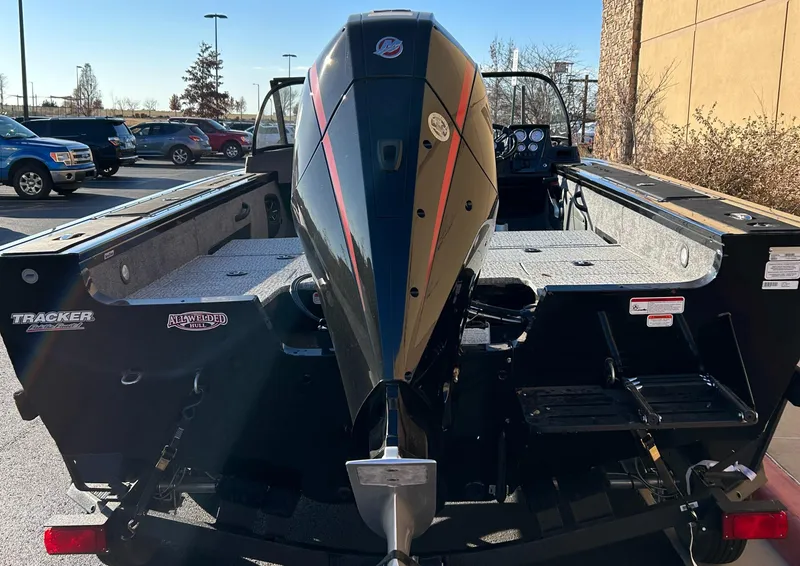 Slide: The Image of 2024 Tracker Targa V-18 Combo boat with powerful outboard motor in parking lot. - 3