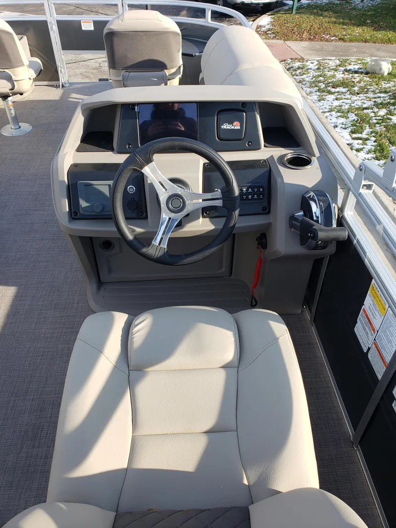 Slide: The Image of 2024 Sun Tracker Fishin' Barge 20 DLX boat helm and seating area. - 4