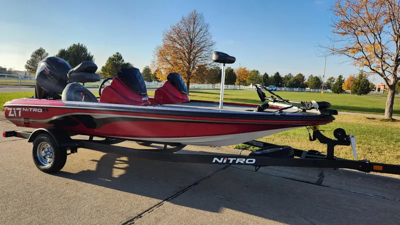 Slide: The Image of 2024 Nitro Z17 bass boat on trailer, parked outdoors. - 1