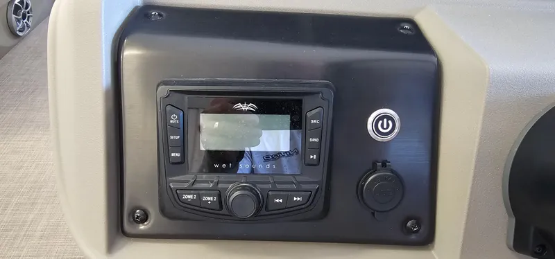 Slide: The Image of 2024 Sun Tracker Party Barge 20 DLX dashboard with control panel and power button. - 11