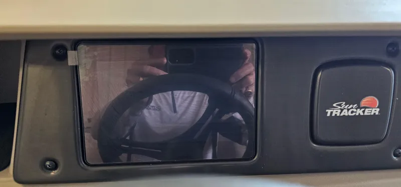 Slide: The Image of 2024 Sun Tracker Party Barge 20 DLX dashboard with steering wheel reflection. - 14